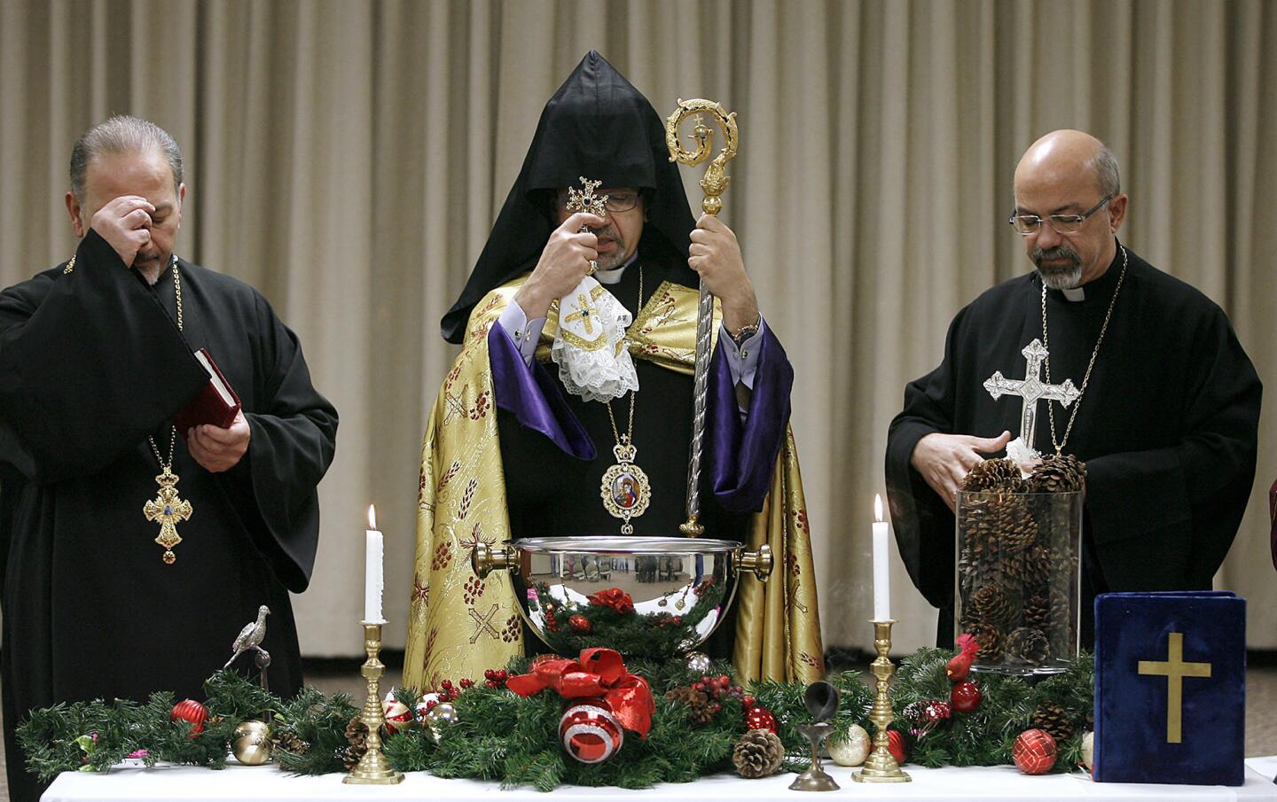 His Eminence Archbishop Moushegh Mardirossian, Prelate of the Armenian Church of the Western United States, center, blesses water with the assistance of Rev. Father Vazken Atmajian, left, and Rev. Father Komitas Torosian right, at Glendale Memorial Hospital in Glendale on Friday, January 4, 2013. His Eminence Mardirossian performed a short ceremony to celebrate New Years and the Armenian Christmas this weekend.