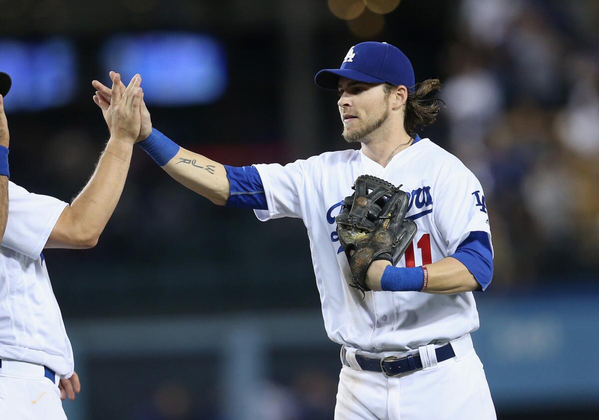 Dodgers outfielder Josh Reddick (11) celebrates with teammates after a 14-1 win over the Rockies on Sept. 24.