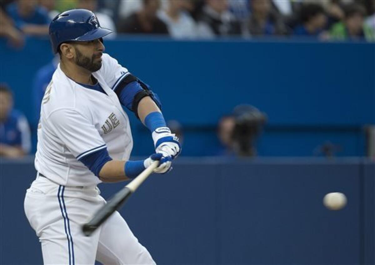 Toronto Blue Jays manager Carlos Tosca, left, argues with third