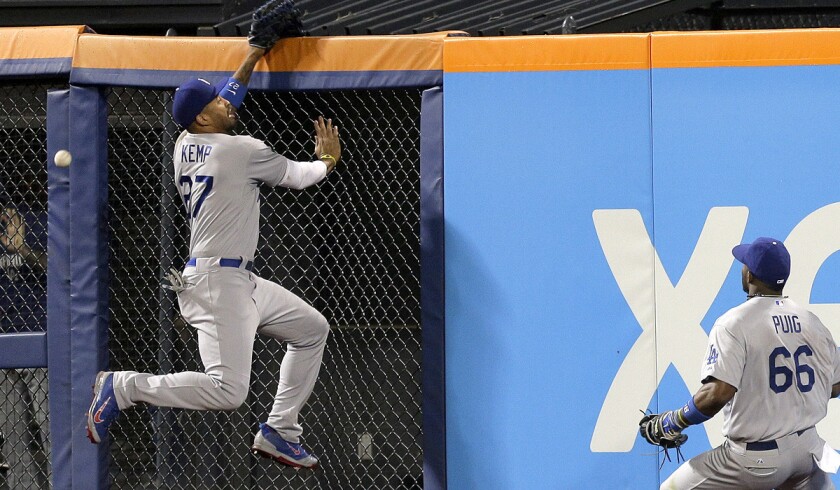 Dodgers center fielder Matt Kemp can't make a leaping catch on a deep drive by the Mets' Curtis Granderson in the eighth inning Thursday in New York.