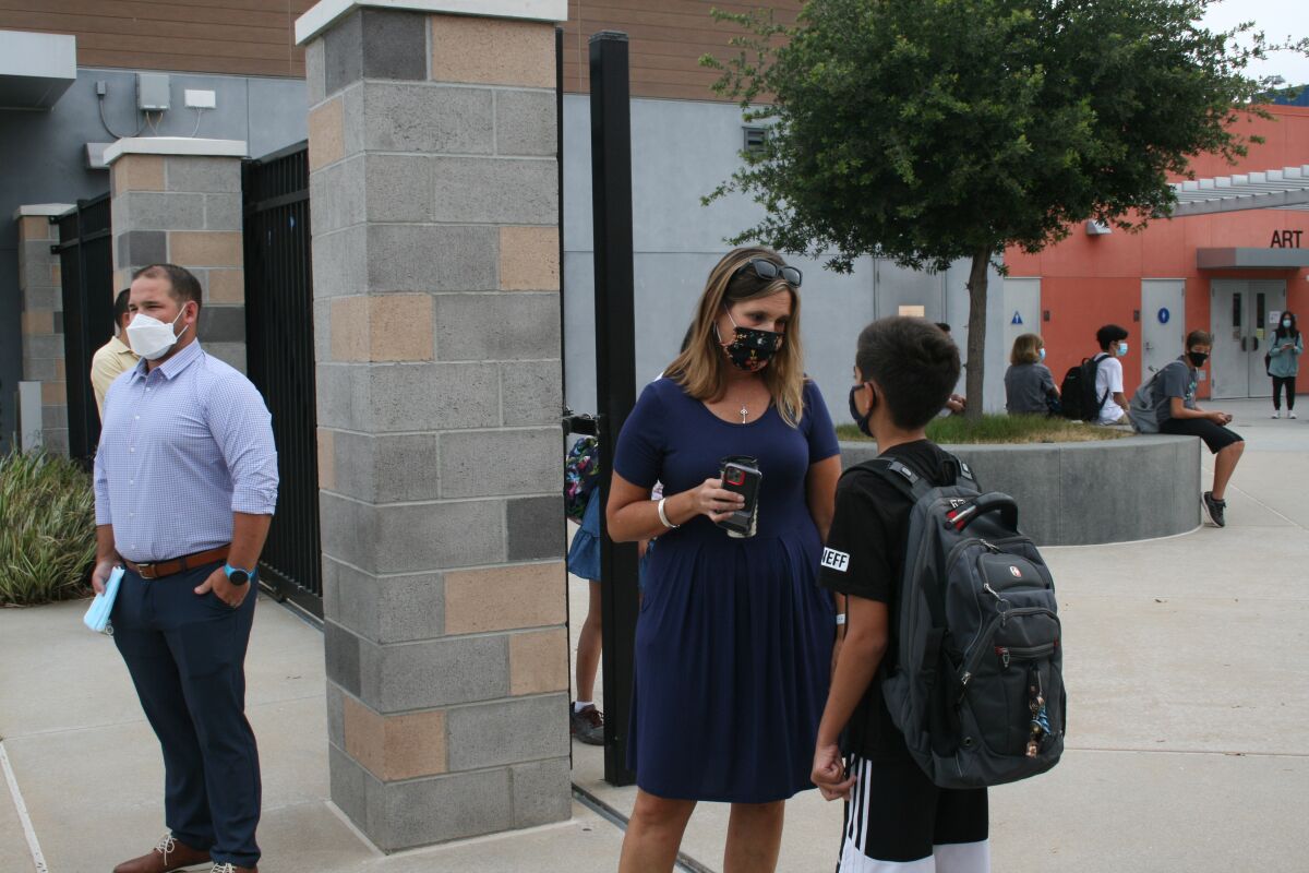 Pacific Trails Middle School Principal Mary Anne Nuskin helps a student on the first day of school.