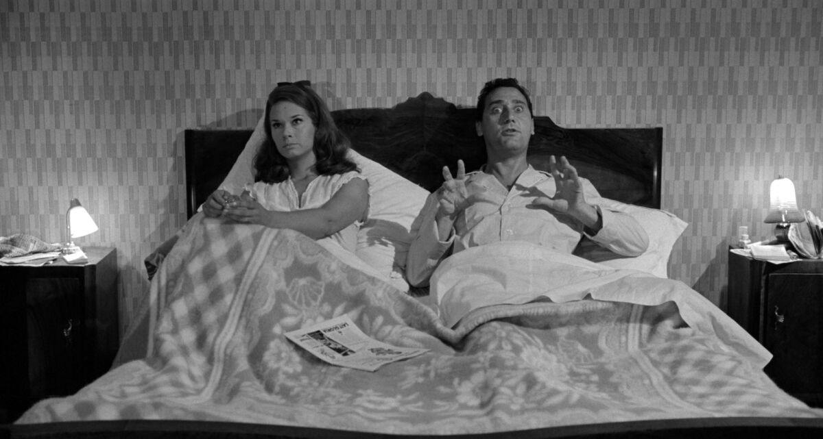 black and white photo of a woman, left, and a man in bed