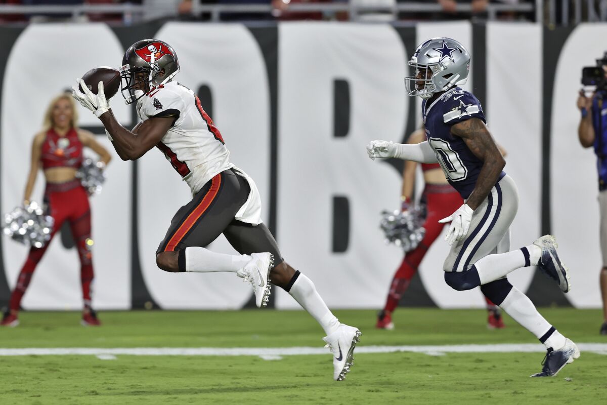 Tampa Bay Buccaneers wide receiver Antonio Brown (81) pulls in a touchdown reception iafter getting around Dallas Cowboys cornerback Anthony Brown (30) during the first half of an NFL football game Thursday, Sept. 9, 2021, in Tampa, Fla. (AP Photo/Mark LoMoglio)