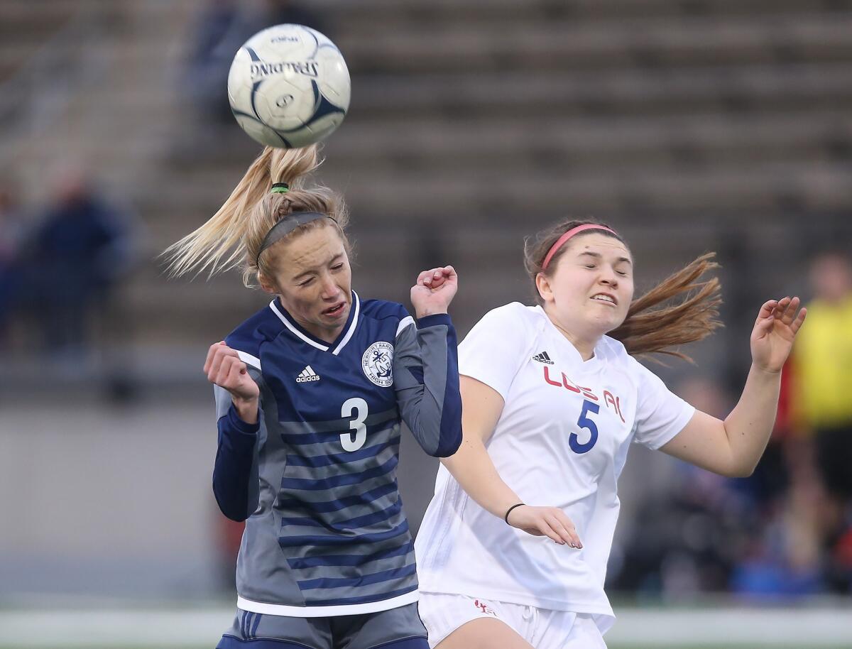 Newport Harbor's Reese Bodas (3) heads the ball as she is bumped by Los Alamitos' Analisa Gjonovich in the quarterfinals of the CIF Southern Section Division 1 playoffs at Davidson Field on Feb. 12.