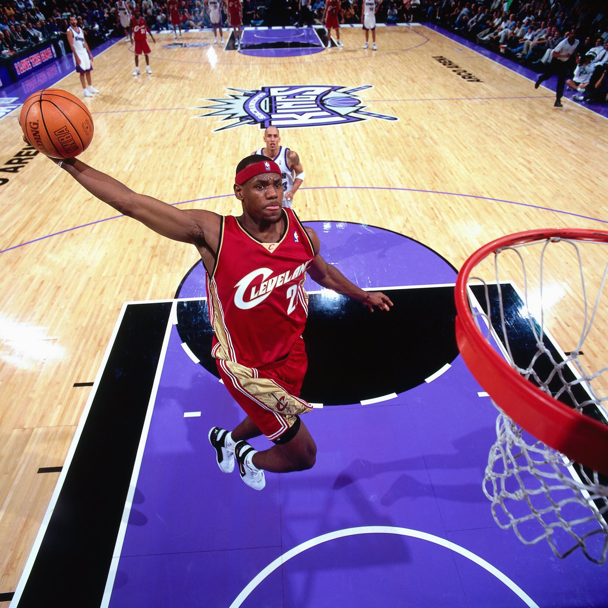 LeBron James elevates for a signature tomahawk dunk Oct. 29, 2003.