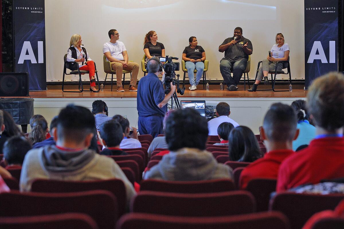 Diane Zuckerman, from left, Giovanni Genitile, Nicole Thompson, Shreya Wagel, Uche Akotabi and Laura Marsh from Beyond Limits speak on a panel held at Roosevelt Middle School on Monday about artificial intelligence as part of Glendale Tech Week. 