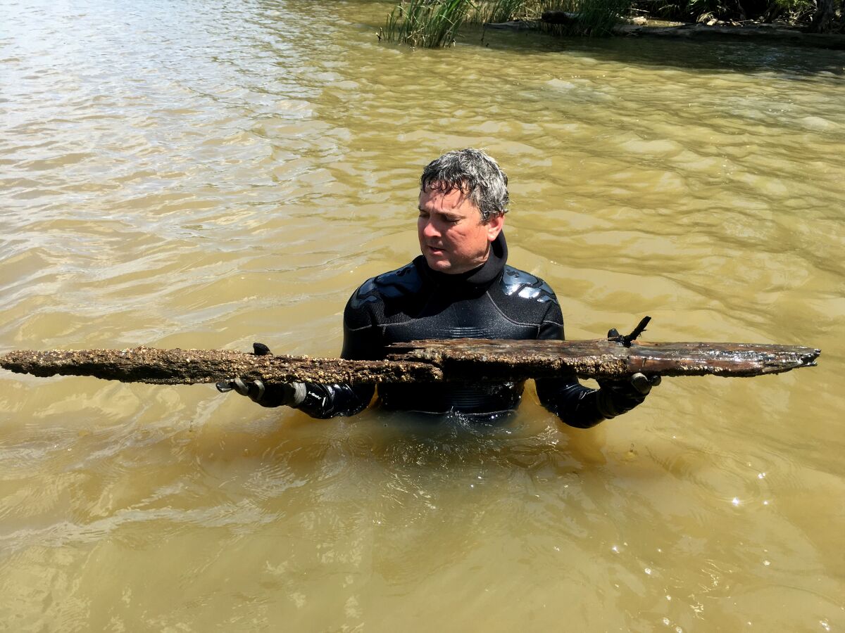 Ben Raines holds the first piece of the Clotilda to see the light of day in 160 years. Raines and a team from the University of Southern Mississippi discovered the wreck in April of 2018, though it was not confirmed and announced until May of 2019.
