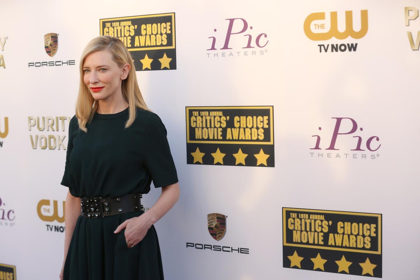 Blanchett dresses down, as in like a real person, proving that red carpet attire doesn't always have to be full-length fantasy wear. The whole outfit is Lanvin--a bottle green long dress in washed stretch crêpe, wide black leather "Eva" belt with crystal detailing, and black suede evening sandals with lacquer stiletto heels. The dress even has pockets. She looks comfortable. Like she can go to dinner afterward--and eat.