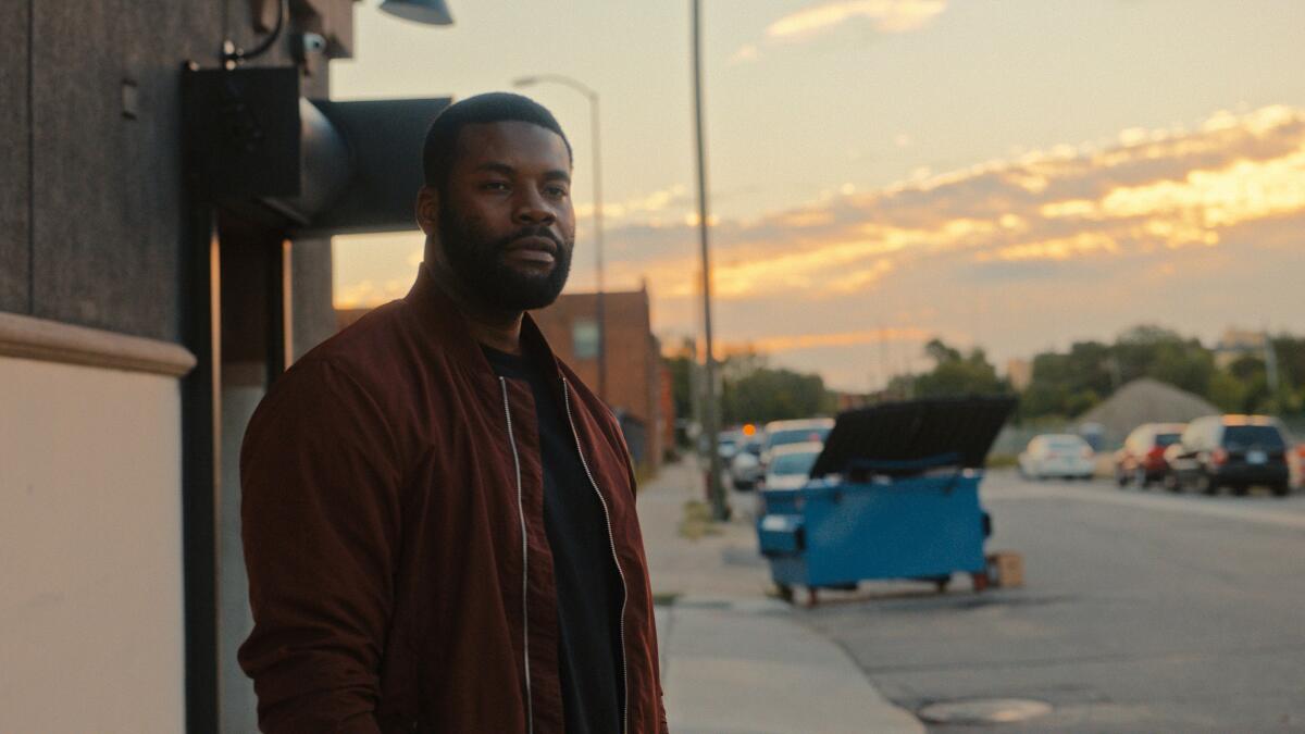 A man stands outside at dusk