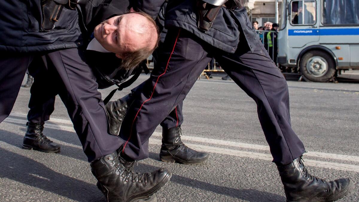Police officers detain a man during an unauthorized anti-corruption rally in central Moscow on March 26, 2017. (Alexander Utkin / AFP/Getty Images)
