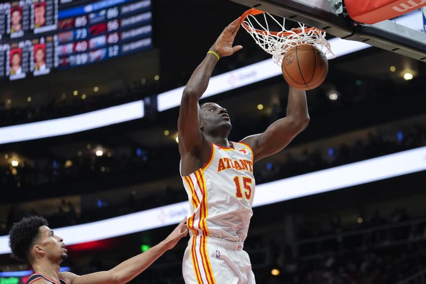 Clint Capela, de los Hawks de Atlanta, encesta delante de Shaedon Sharpe, de los Trail Blazers de Portland, en el encuentro del miércoles 27 de marzo de 2024 (AP Foto/John Bazemore)