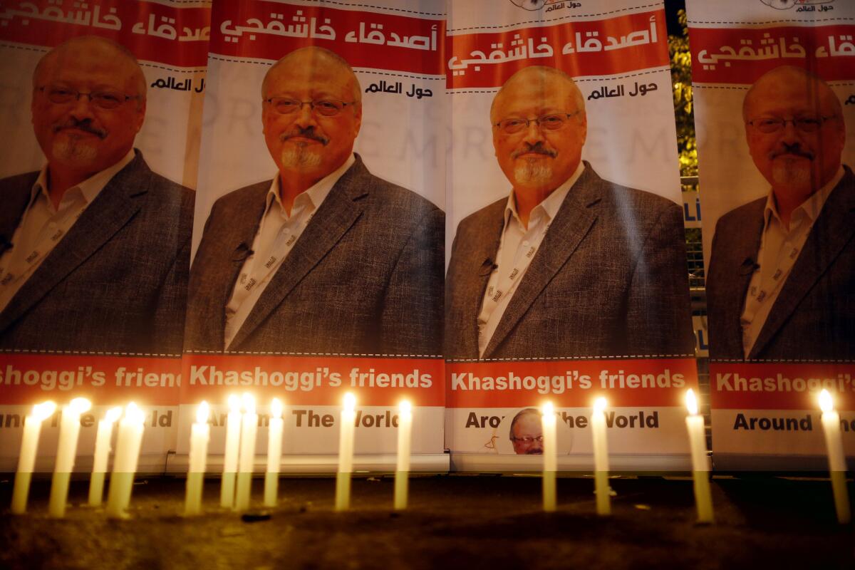 In this Oct. 25 photo, candles are lit in front of a photo of Saudi journalist Jamal Khashoggi.