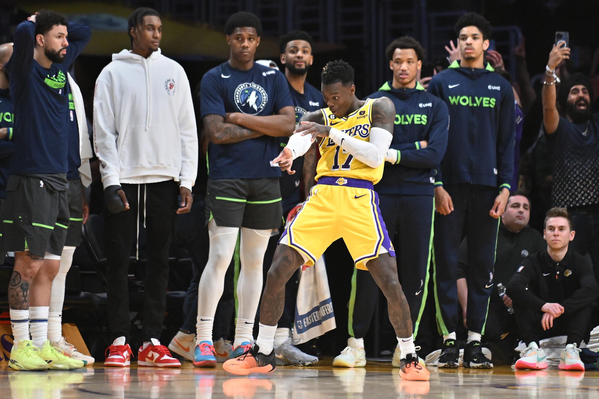 Lakers guard Dennis Schroder strikes the "freeze" pose in front of the Timberwolves bench after making a go-ahead 3-pointer.