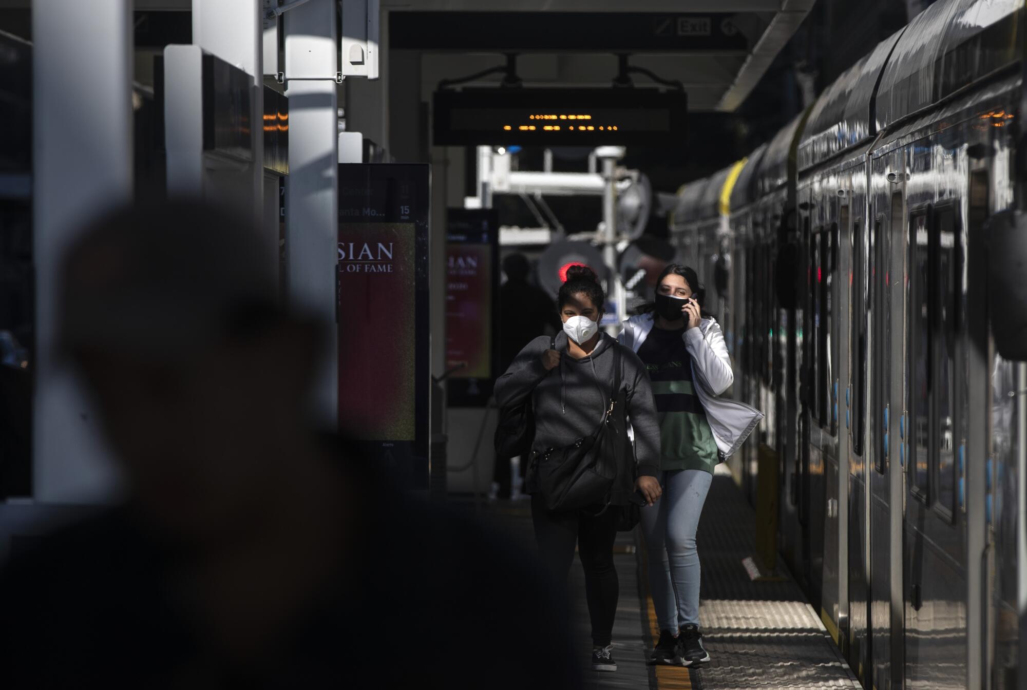 Metro A Line riders exit a train at Pico Station.