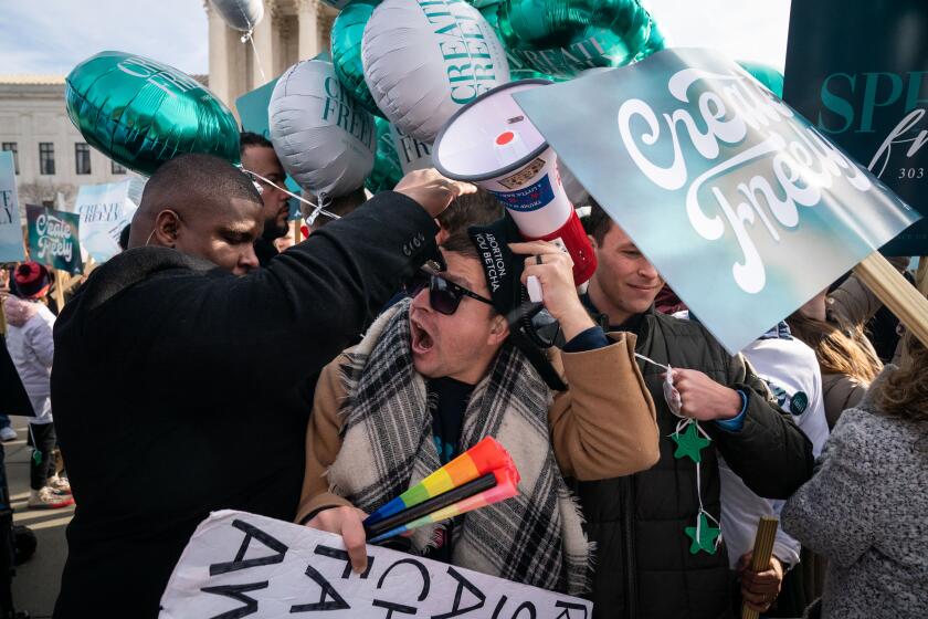 WASHINGTON, DC - DECEMBER 05: Protesters shove each other as they gather in front of the Supreme Court of the United States on Monday, Dec. 5, 2022 in Washington, DC. The High Court heard oral arguments in a case involving a suit filed by Lorie Smith, owner of 303 Creative, a website design company in Colorado who refused to create websites for same-sex weddings despite a state anti-discrimination law. (Kent Nishimura / Los Angeles Times)