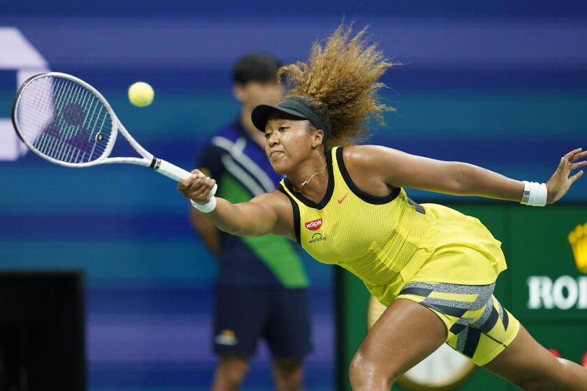 Naomi Osaka, of Japan, returns a shot to Marie Bouzkova, of the Czech Republic, during the first round of the US Open tennis championships, Monday, Aug. 30, 2021, in New York. (AP Photo/Elise Amendola)