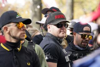 FILE - People identifying themselves as members of the Proud Boys join supporters of President Donald Trump for pro-Trump marches, Nov. 14, 2020, in Washington. Two supporter in the center are wearing hats with red lettering that read “RWDS,” which is short for “Right Wing Death Squad.” The gunman who killed eight people on Saturday, May 6, 2023, at a Dallas-area mall was wearing a “RWDS” patch. The phrase has been embraced in recent years by far-right extremists who glorify violence against their political enemies. (AP Photo/Jacquelyn Martin, File)