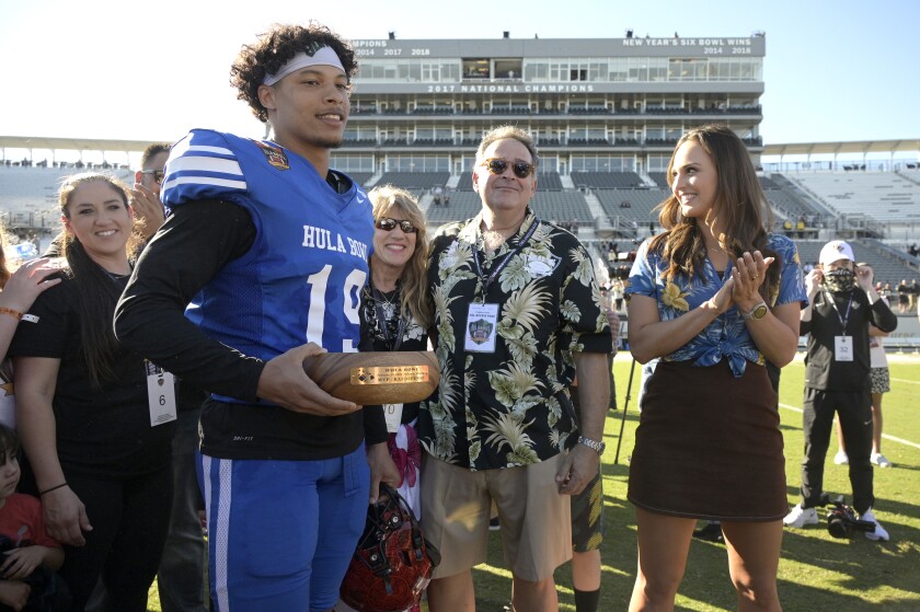 Team Kai cornerback Tayler Hawkins of San Diego State receives the defensive MVP trophy for his team after the Hula Bowl.