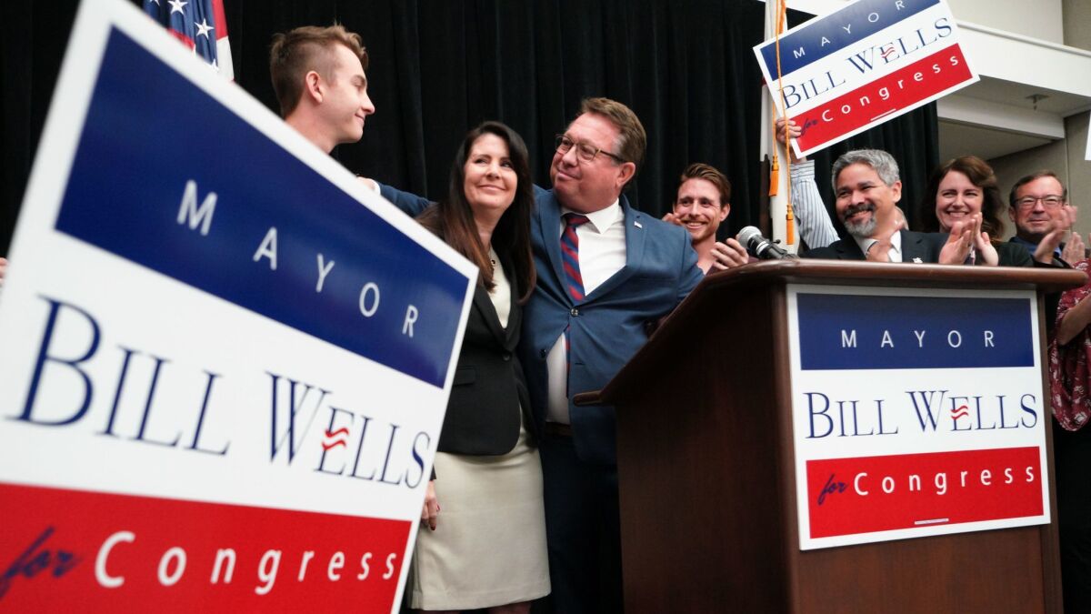Standing with his wife, Bettie and sons, Matt (right) and Eli (left), El Cajon Mayor Bill Wells on Tuesday at a press conference announced his candidacy for the 50th Congregational District.