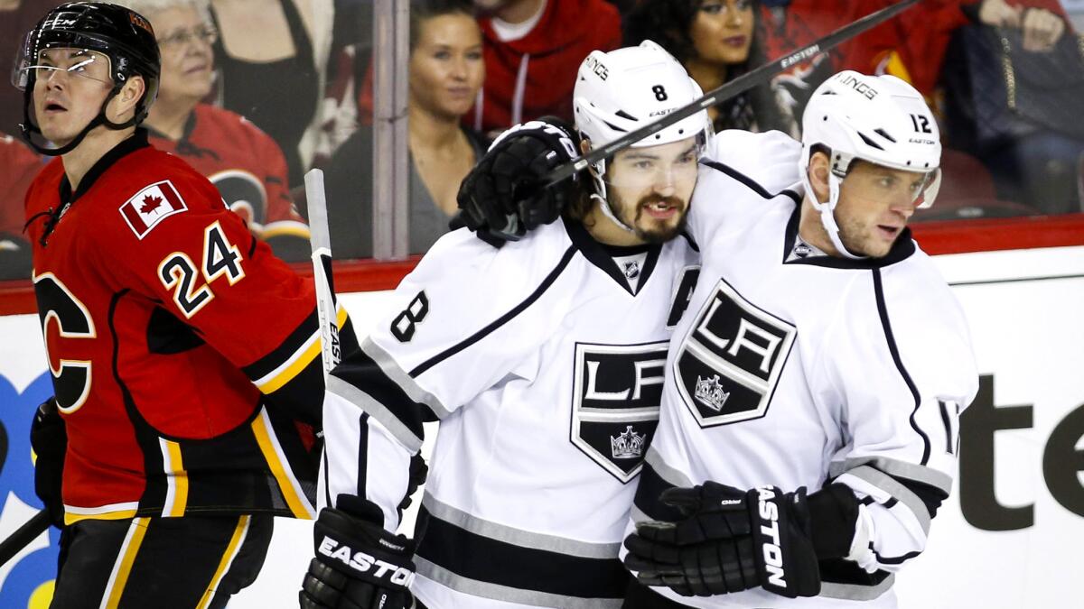 Kings defenseman Drew Doughty (8) celebrates with right wing Marian Gaborik, who scored against the Flames in the second period Thursday night.