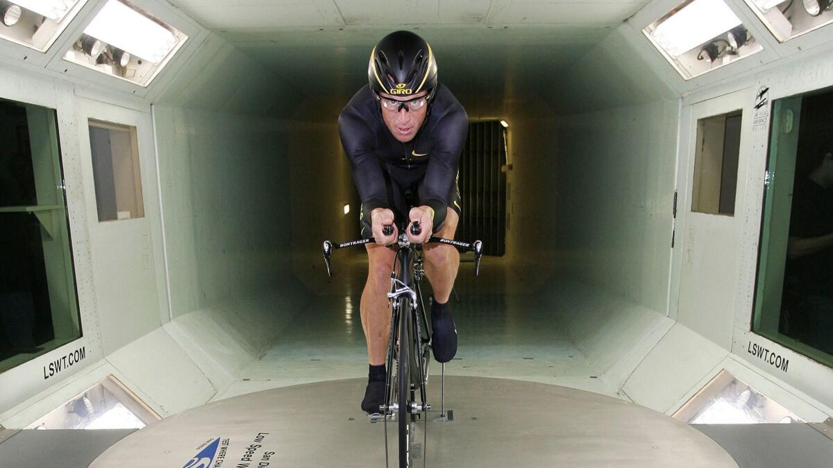 Cyclist Lance Armstrong warms up before riding a Trek prototype bicycle at the wind tunnel in 2008.