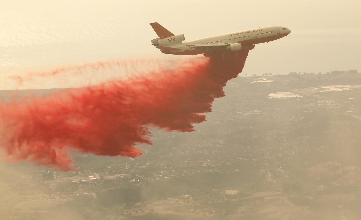An air tanker drops fire retardant on the Cave fire