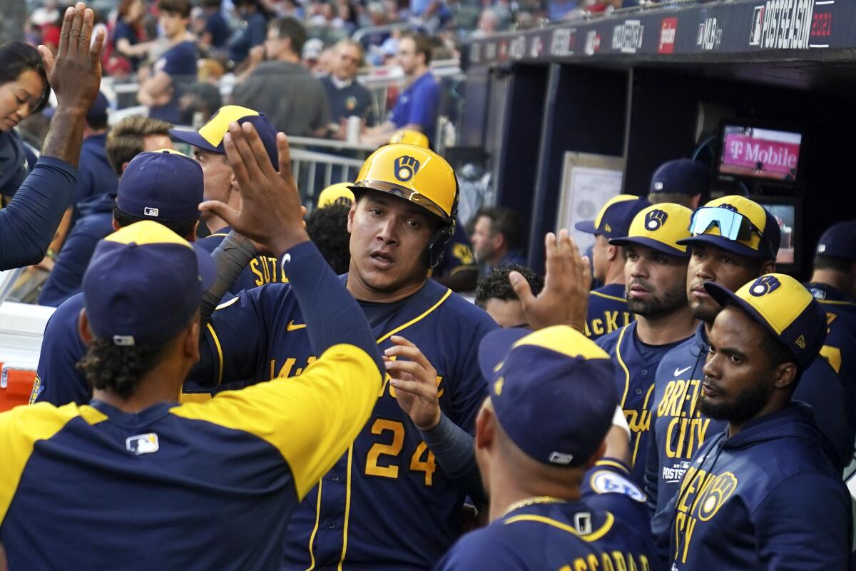 Milwaukee Brewers right fielder Avisail Garcia (24) after Milwaukee Brewers catcher Omar Narvaez hit an RBI single during the fourth inning of Game 4 of a baseball National League Division Series against the Atlanta Braves, Tuesday, Oct. 12, 2021, in Atlanta. (AP Photo/Brynn Anderson)