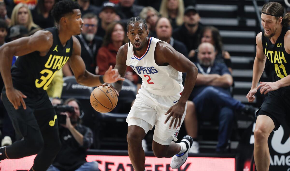 Clippers star Kawhi Leonard controls the ball during a 120-118 loss to the Utah Jazz on Friday.
