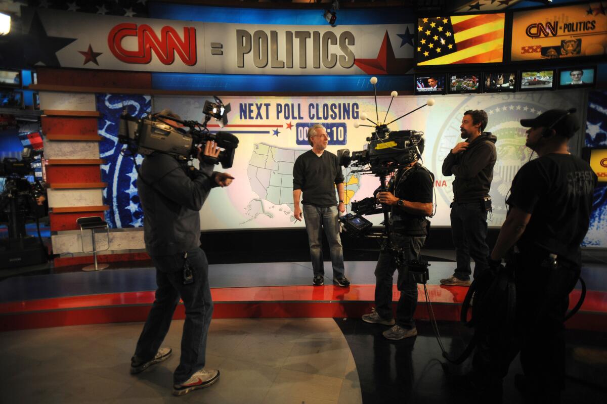 Anchor Wolf Blitzer and CNN crew members rehearse on the set.