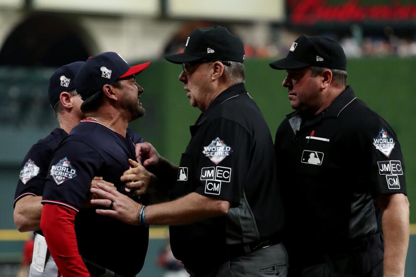 HOUSTON, TX - OCTOBER 29: Manager Dave Martinez #4 of the Washington Nationals argues with Home Plate umpire Sam Holbrook #34 during Game 6 of the 2019 World Series between the Washington Nationals and the Houston Astros at Minute Maid Park on Tuesday, October 29, 2019 in Houston, Texas. (Photo by Rob Tringali/MLB Photos via Getty Images)