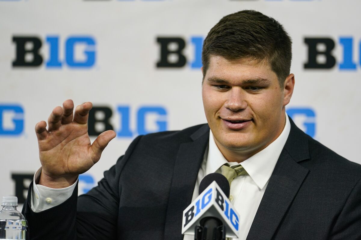 FILE - Iowa center Tyler Linderbaum talks to reporters during an NCAA college football news conference at the Big Ten Conference media days at Lucas Oil Stadium in Indianapolis, in this Friday, July 23, 2021, file photo. The move from defensive line to center pushed Iowa's Tyler Linderbaum out of his comfort zone. Linderbaum quickly adapted to the position in a program that has traditionally featured strong offensive lines. He said the offensive line's emphasis on fundamentals and drill work pushed him along. (AP Photo/Michael Conroy, File)