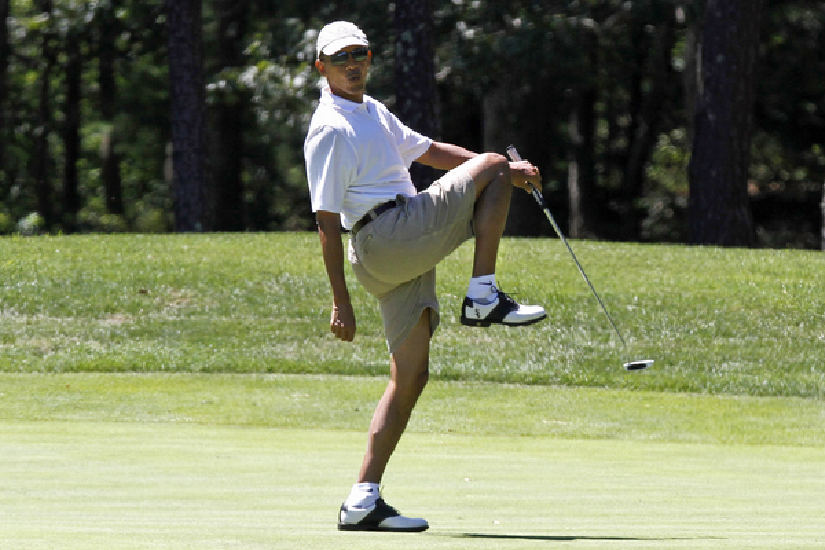President Obama reacts as he misses a shot while golfing on the first hole at Farm Neck Golf Club in Oak Bluffs, Mass., on the island of Martha's Vineyard.