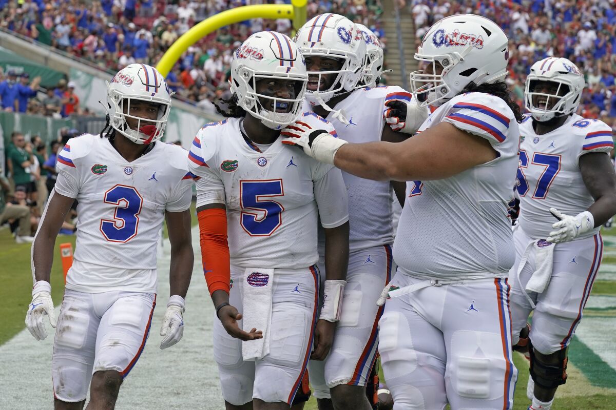 Florida quarterback Emory Jones celebrates with teammates after his touchdown run against South Florida.