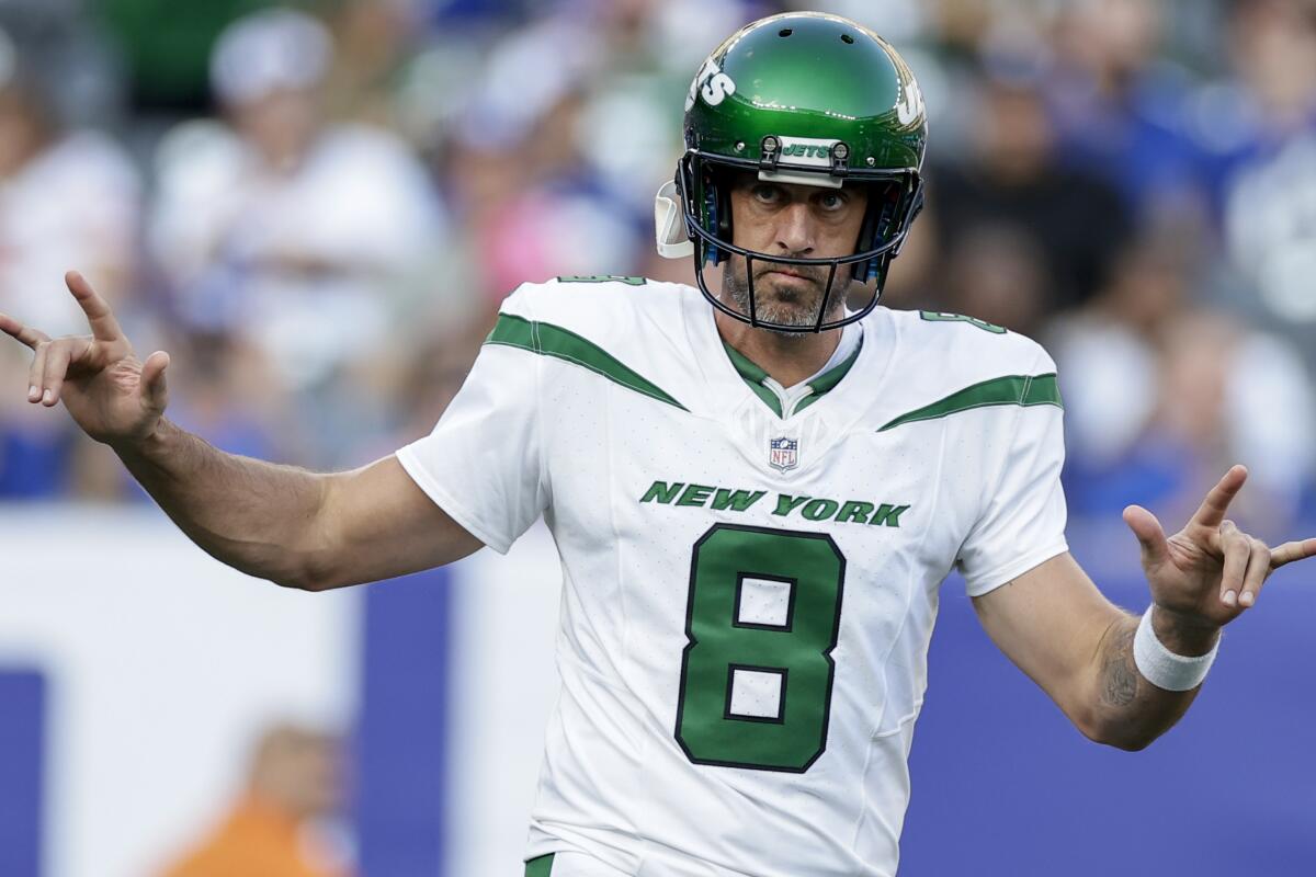 New York Jets quarterback Aaron Rodgers (8) sets up for a play 