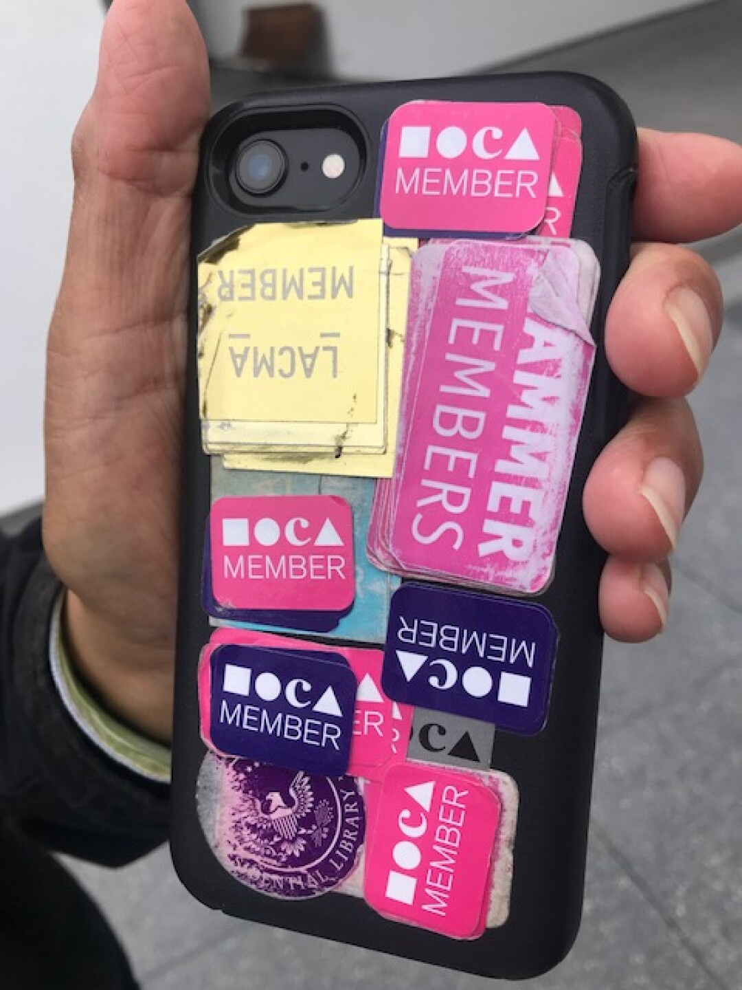 The back of Ben Barcelona’s phone, which features layers of museum membership stickers, a testament to his devotion.