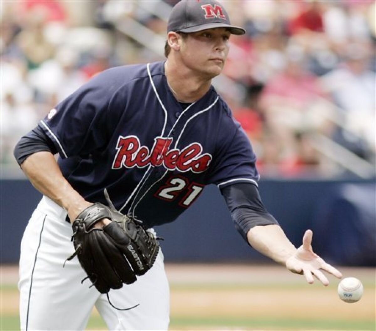 Mississippi pitcher Nathan Baker tosses the ball to first base for a ground-out by Virginia during an NCAA super regional Baseball championship game in Oxford, Miss., Sunday, June 7, 2009. (AP Photo/Rogelio V. Solis)
