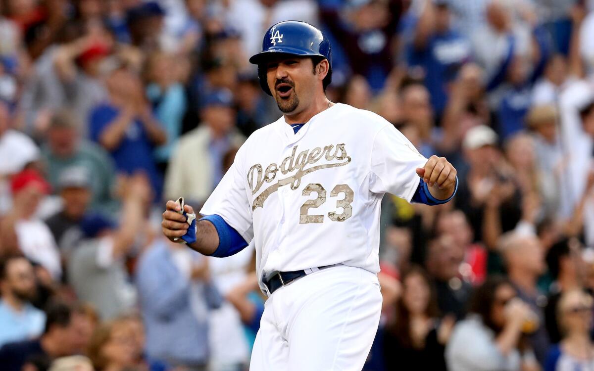 Dodgers' Adrian Gonzalez celebrates as he scores the game-tying run in the fifth inning against the Angels.