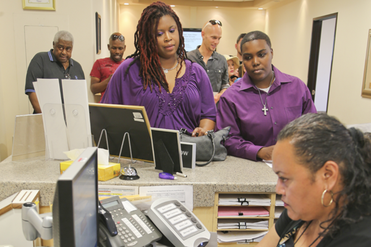 Rika Grier, left, and her partner Pastor Nicki Fairley, wait to obtain a license from the San Diego County marriage bureau. The San Diego County clerk is seeking to block the issuance of marriage licenses for same-sex couples.