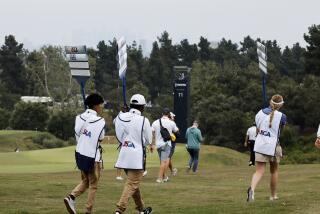 LOS ANGELES, CA - JUNE 14: Sign bearers walk the 15th fairway with a cloudy downtown skyline during the practice rounds at The Los Angeles Country Club on Wednesday, June 14, 2023 in Los Angeles, CA. (Gina Ferazzi / Los Angeles Times)