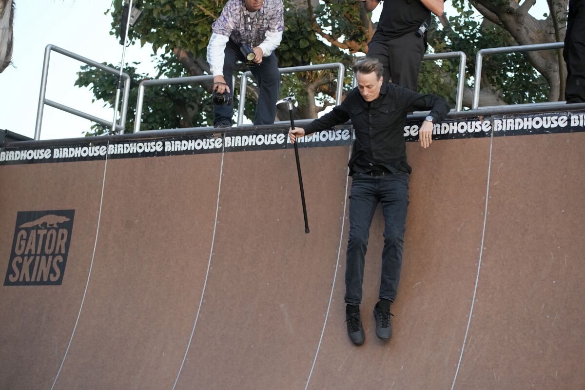 Cane in hand due to recent injury, Tony Hawk slides down ramp at premiere of "Tony Hawk: Until the Wheels Fall Off."