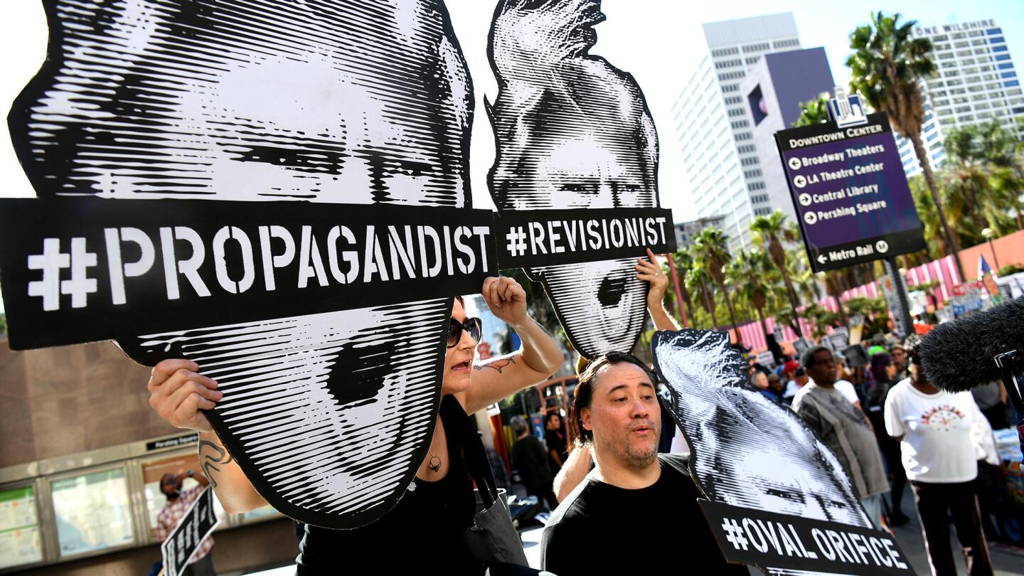 Anti-Trump protesters rally at the intersection of 5th and Hill streets in downtown Los Angeles on Saturday.