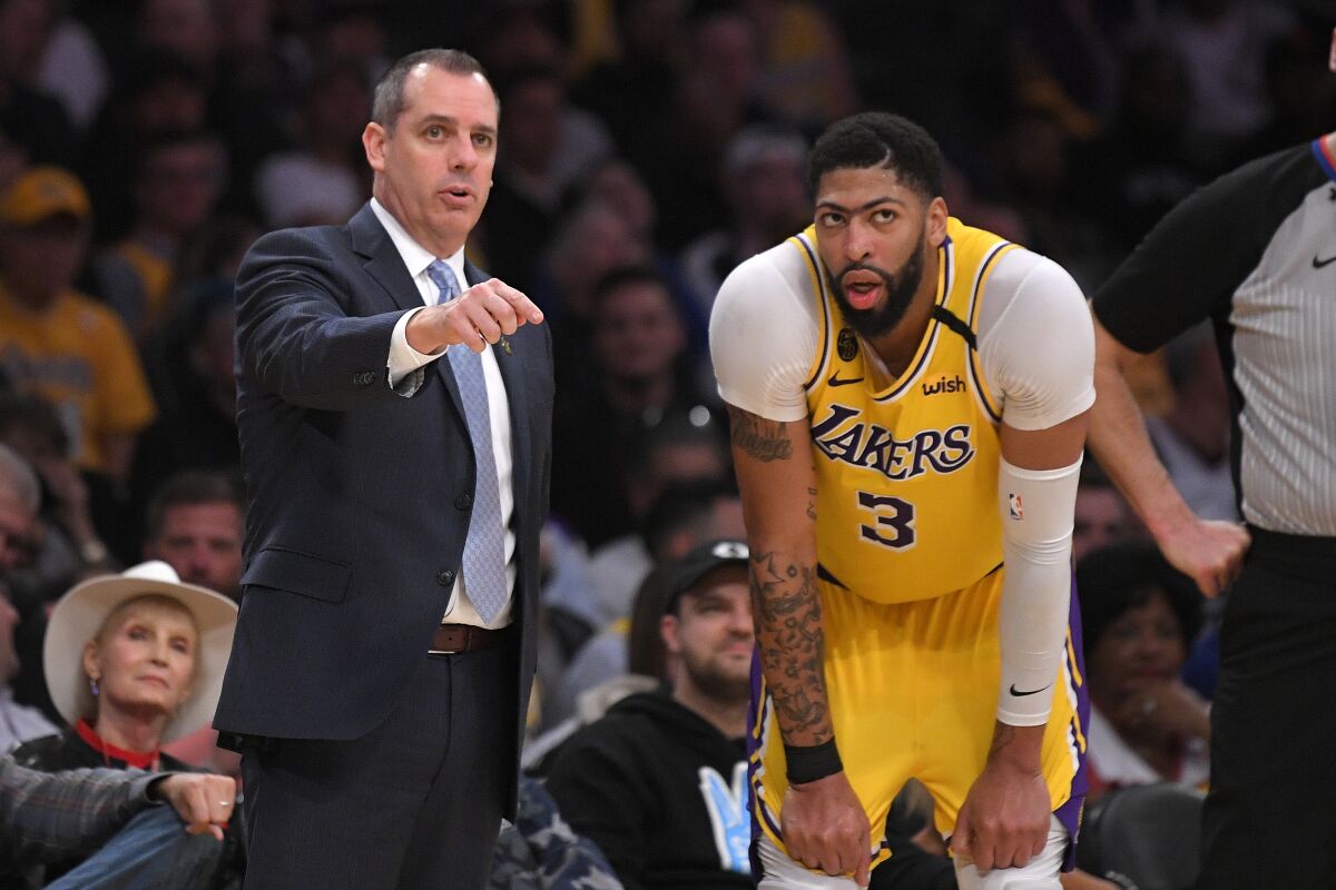 Lakers head coach Frank Vogel talks with forward Anthony Davis during a game in March.