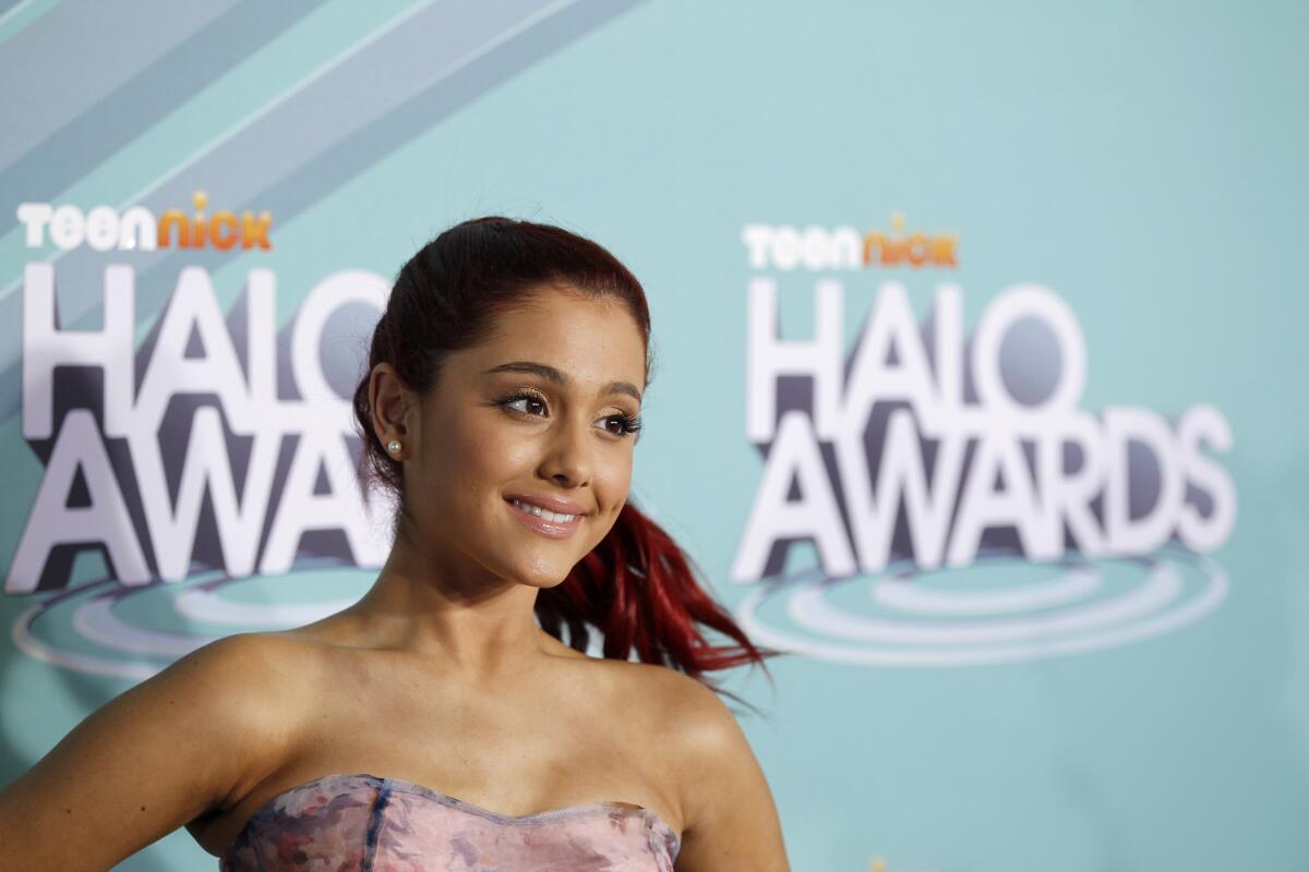 A teenage girl with red hair in a ponytail smiling against a blue backdrop that reads 'Teen Nick Halo Awards'