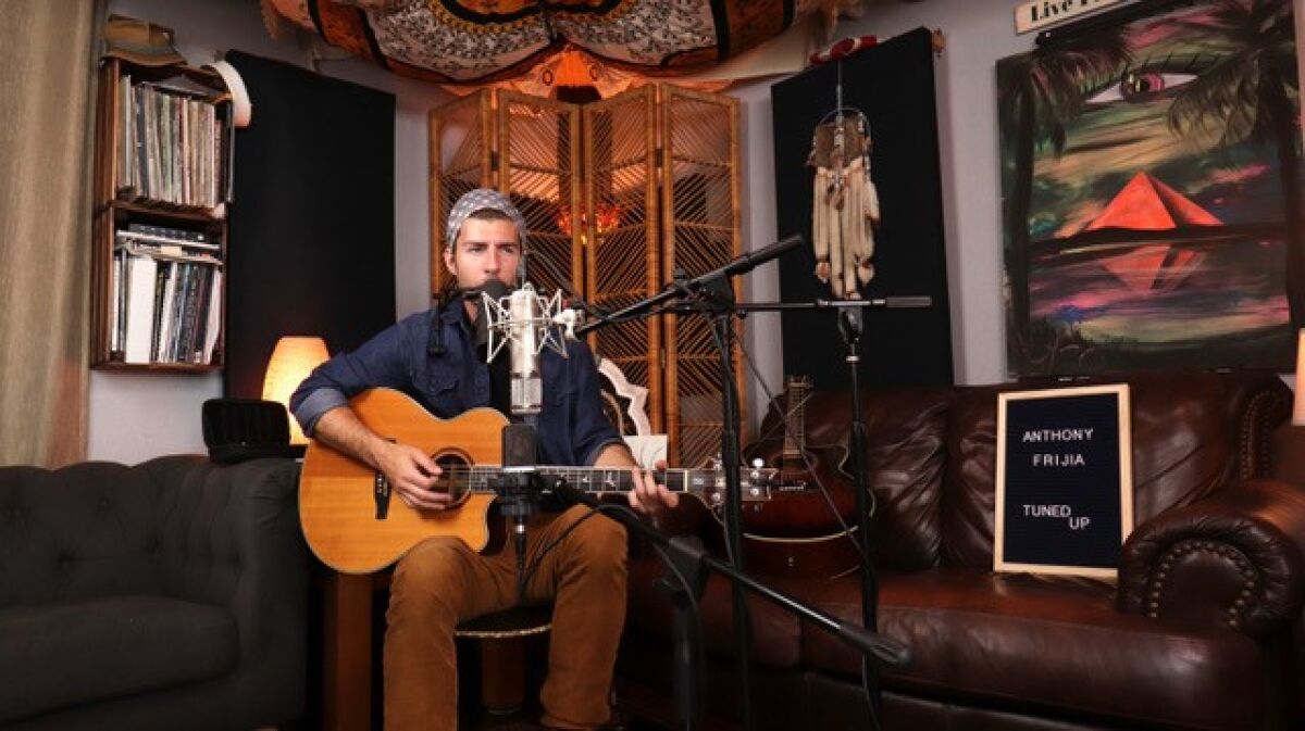 Anthony Frijia preps for a session recorded in DharmaDen's original location in co-founder Eric Neilson's Ocean Beach home.
