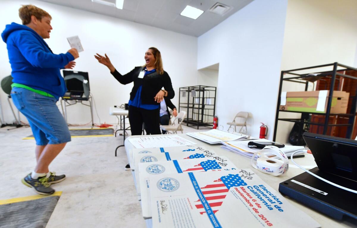 Ballots are dropped off at an Early Vote Center in Huntington Beach on Oct. 27 as voting begins in Orange County.