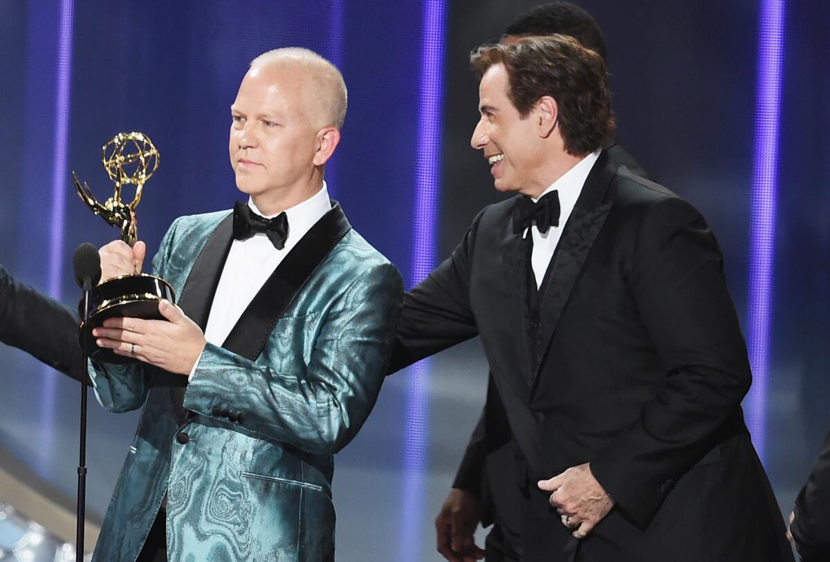 Write-/producer Ryan Murphy, left, and actor John Travolta accept outstanding limited series for "The People v. O.J. Simpson: American Crime Story."