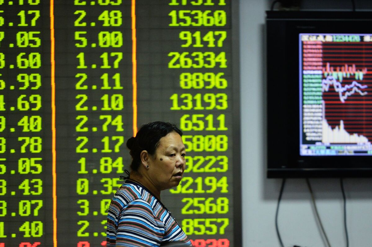 An investor observes trading at a stock exchange in Hangzhou, China.