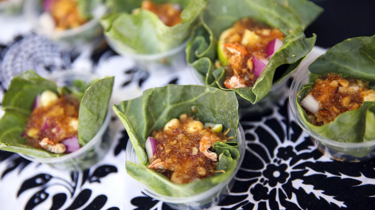 Miang Kham, a traditional Thai snack with shrimp, shallots, red onion, chili peppers, ginger, garlic, lime, roasted coconut, peanuts in a Chinese broccoli leaf wrapper from Lum-Ka-Naad.