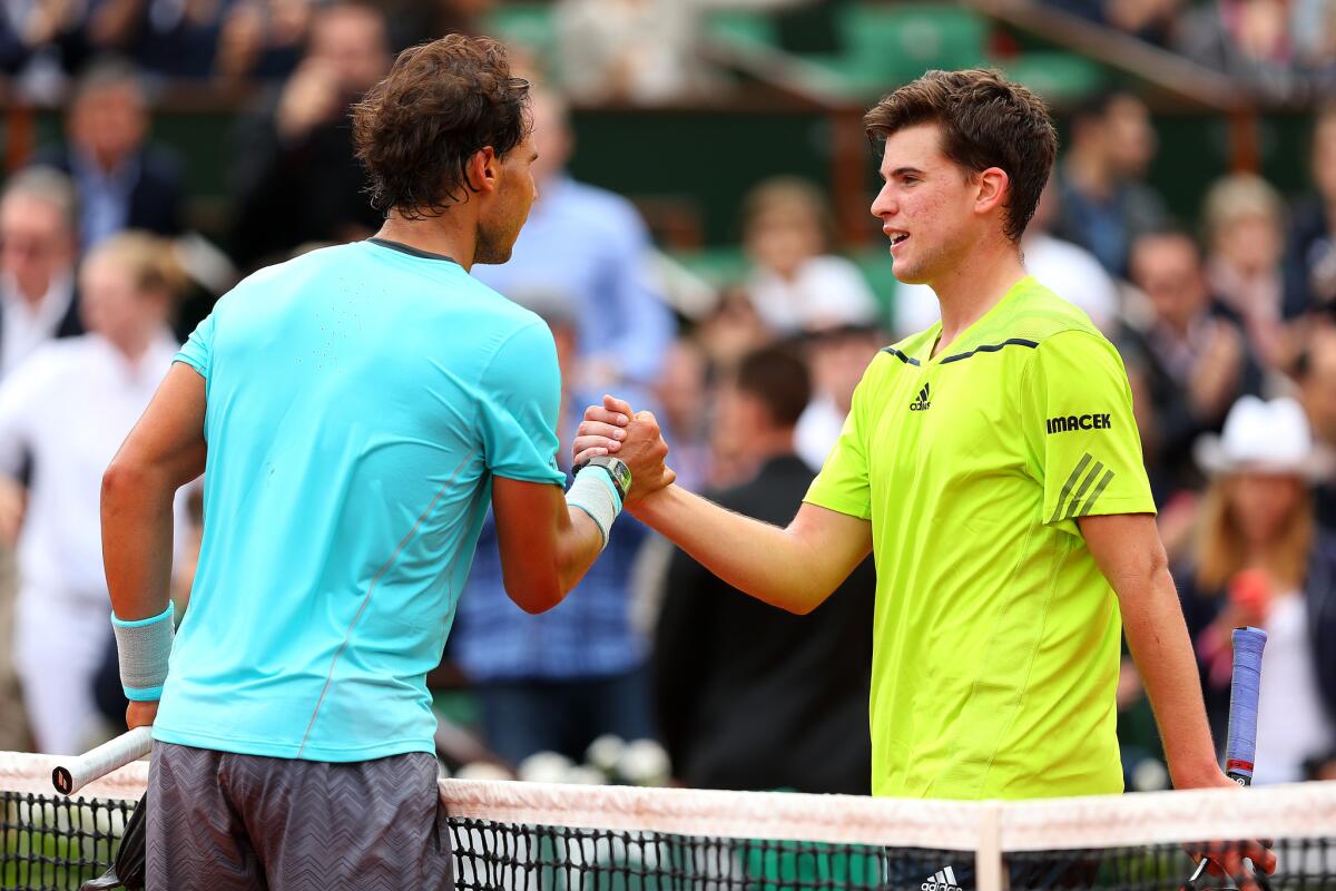 Rafael Nadal, left, shakes hands with 20-year-old Dominic Thiem after their French Open match on Thursday. Nadal, who won in straight sets, said Thiem could be a big part of tennis' future.