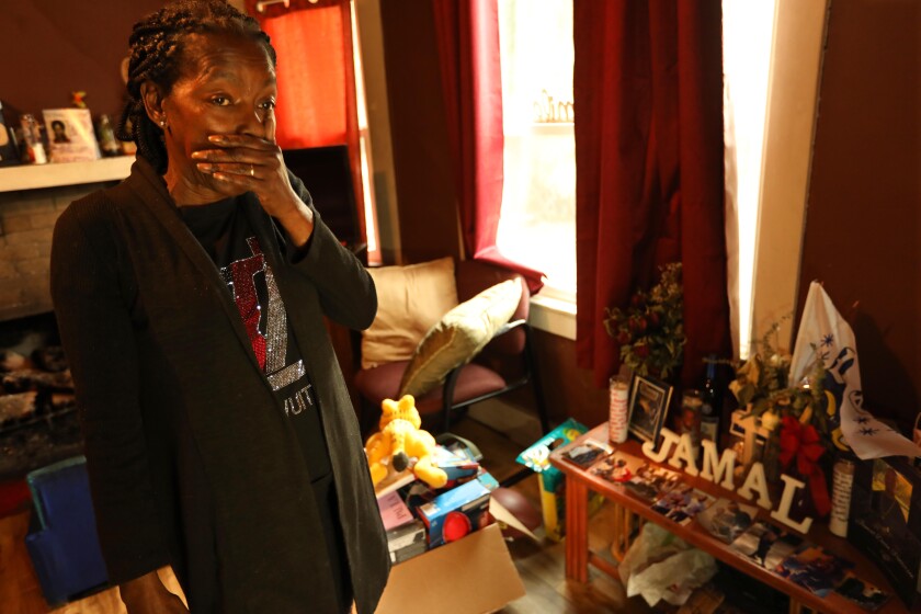 Lisa Lewis mourns the loss of her son, Jamal Patterson, near a makeshift memorial in her home in Pasadena.